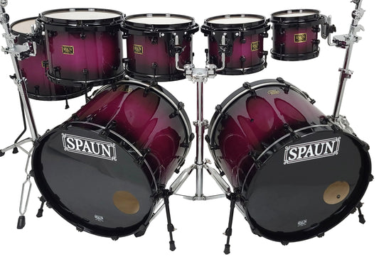 A 7-piece drum kit by SPAUN with a glossy dark purple to black gradient finish, mounted on a silver chrome hardware stand against a white studio background.